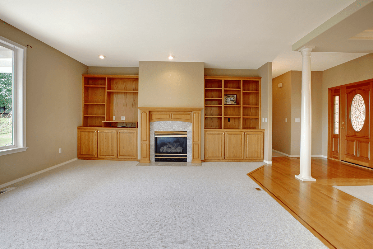 Living room with fireplace and built-in shelves.